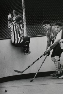 Street hockey in Cranston, R.I.: Kenny Di Raimo jumps out of the way during game action