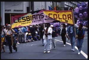 Marchers in the San Francisco Pride Parade carrying banner 'Lesbians of Color, Pacific Center, Berkeley'