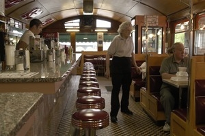 Waitress with customers at a booth, Miss Florence Diner