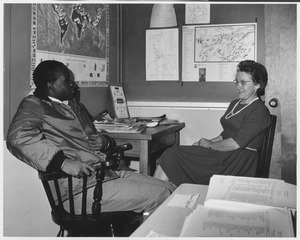 Evelyn H. Russell seated in office with Peter Makhambera
