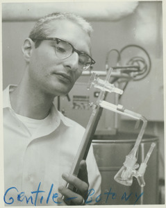 Arthur Christopher Gentile standing indoors, working in laboratory on equipment