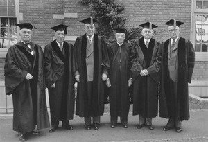 Hugh P. Baker with unidentified men in academic gowns on commencement weekend