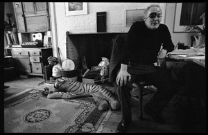 W. Eugene Smith, seated at a desk in his home