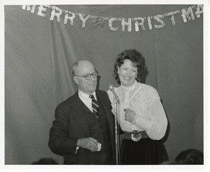 Jeremiah Milbank, Jr. with an unidentified woman at Christmas party