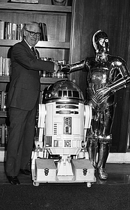 Unidentified man with C-3P0 and R2-D2 from Star Wars films at Boston City Hall