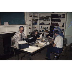 Men and women sitting around a table with medical equipment