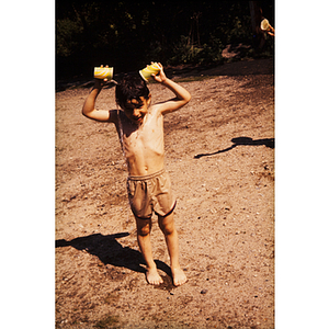 Child pouring water on himself