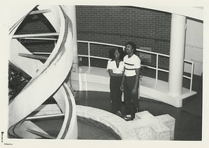 Two students looking up at the DNA strand in Bemis Hall