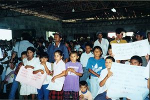 Children holding signs at an event in El Salvador, November 1999