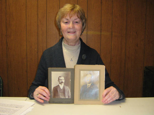 Marie Ahearn with a picture of her relatives Jack Fogarty and John McDonald