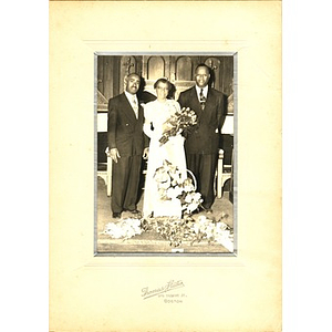 Laymon Hunter poses with a bride and groom