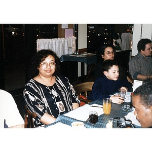 Inquilinos Boricuas en Acción employees at a table in a restaurant awaiting their meals.