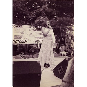 Young woman singing on the outdoor stage at Festival Betances.