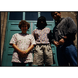 Three Tri-Club staff members posing in front of a door