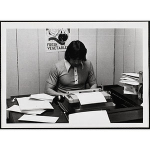 Charlie Mc Gough, a staff member of the Charlestown Boys & Girls Club, sitting at a typewriter