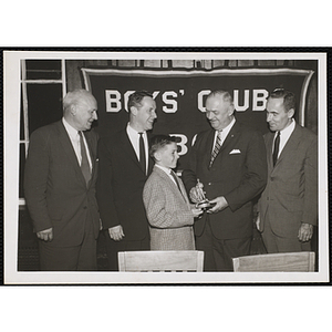 William Birmingham, President of the South Boston Kiwanis Club, presenting an award to a boy while others look on at the 19th Annual Awards Night