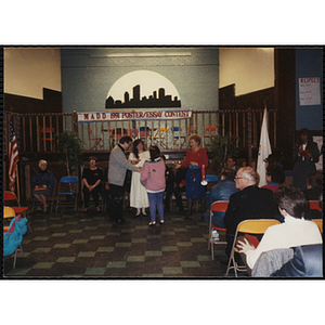 A man and two women presenting an award in the MADD 1991 Poster and Essay Contest