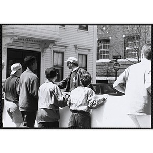 Jerry Steimel, Charlestown Clubhouse director, facing left, standing in front of five boys holding a banner at the Boys and Girls Clubs of Boston 100th Anniversary Celebration Parade