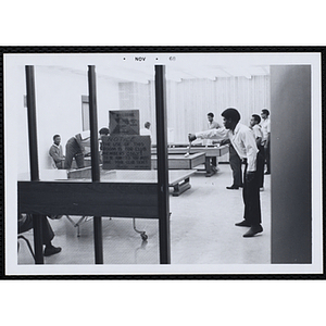 A Group of teenagers playing table tennis and pool in the game room