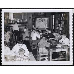 Pairs of boys play checkers in a library
