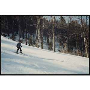 A boy skis down a slope