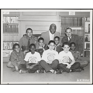 "Auspices of Boys' Clubs of Boston and Boston Council Boy Scouts," including Jackie Robinson, the first African-American Major League Baseball player, center in the back row, posing together on Jackie Robinson Day at the Boys' Clubs of Boston Roxbury Clubhouse