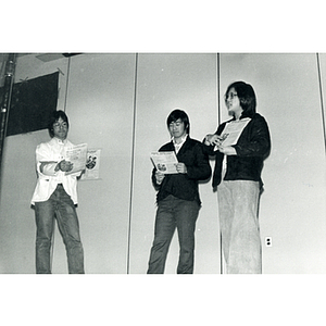 Two men and a woman perform a theatrical sketch onstage at the Josiah Quincy School about the normalization of U.S. and China relations