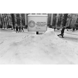 "Welcome to Northeastern University" sign buried in snow in the quadrangle
