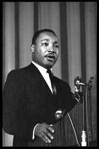 Martin Luther King, Jr., speaking from a podium