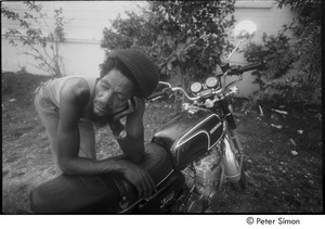 Alvin 'Seeco' Patterson leaning over a motorcycle