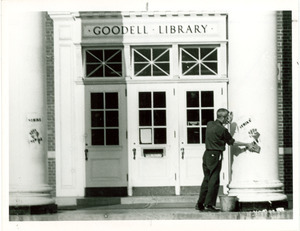 Unidentified man removes graffiti from Goddell Hall