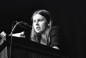 Bernadette Devlin McAliskey at the podium during a talk at Northeastern University