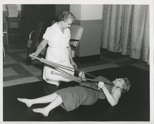 Physical therapist assisting Mrs. Frances Marsala in her exercises using crutches