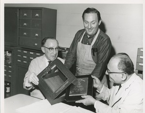 Three men place the 1966 President's Trophy in its box