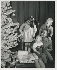 Woman and three children with Christmas tree