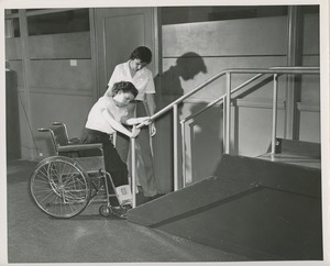 Physical therapist helping young woman on stairs