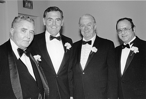 Mayor Raymond L. Flynn posing in a tuxedo with Councilors Albert "Dapper" O'Neill, James M. Kelly and an unidentified man