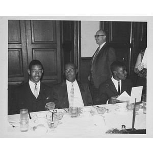 Youth and men at table at Black Achievers dinner