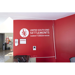 Harriet Tubman House red wall behind front desk area