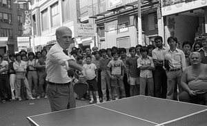 Mayor Kevin White playing table tennis at the 1979 August Moon Festival