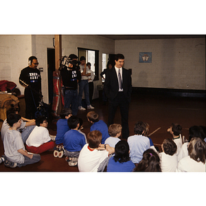 IBEW television crew filming man addressing children at the Eastern Middlesex Family YMCA