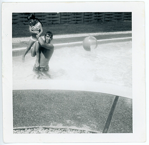Bob Mello holding child in pool