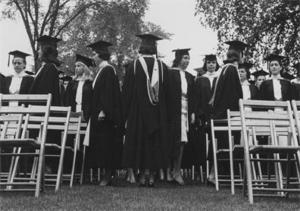 Twelve students in caps and gowns : Wheaton College, Class of 1964.