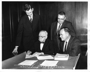 Suffolk University officials Frank J. "Daisy" Donahue and Francis X. Flannery sign a contract related to the newly built Donahue Building (41 Temple Street)