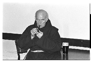 Visiting friar having a smoke and a Guinness in a pub in Co. Down