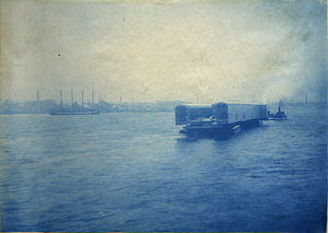 [Unidentified bridge structure being transported over water by tugboats]