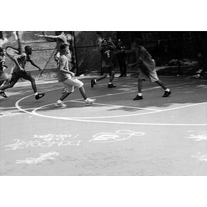Kids playing basketball in a playground in the Villa Victoria neighborhood.