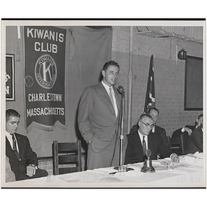 A man speaking at the head table during an awards event held by the Boys' Clubs of Boston and the Charlestown Kiwanis Club