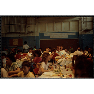 Children and adults eat and converse at the tables during a Boys & Girls Club Awards Night