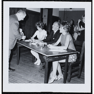 A Boys' Club staffer serves the panel of judges, including Charles H. Hood, at center, during a Little Sister Contest